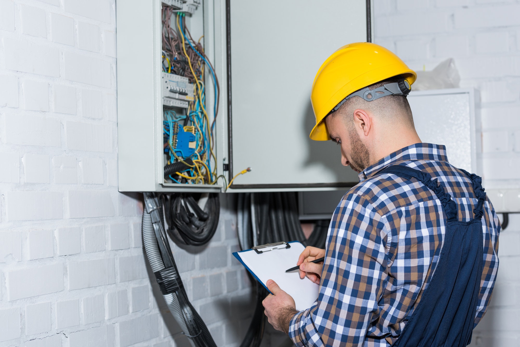 professional electrician inspecting wires in electrical box.jpg